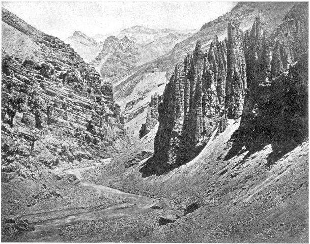 Mountain gorge, Himalayas, India. Note the difference
in the slope of the eroded rocks and the effect of erosion upon them;
also the talus slopes at the base of the cliffs which the torrent is
cutting away. On the left of the foreground there is a little bench
showing a recent higher line of the water.