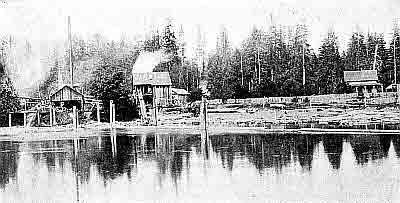 River; felled logs; docking pillars; tall smokestack; frame buildings; two-story house.